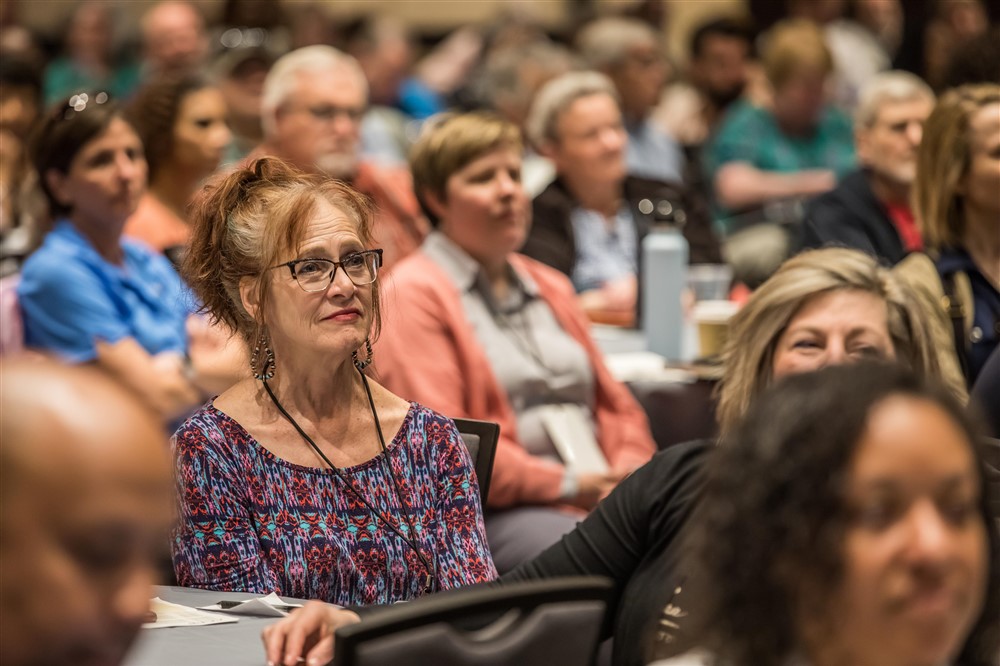 a crowd of ACPE members at the annual conference